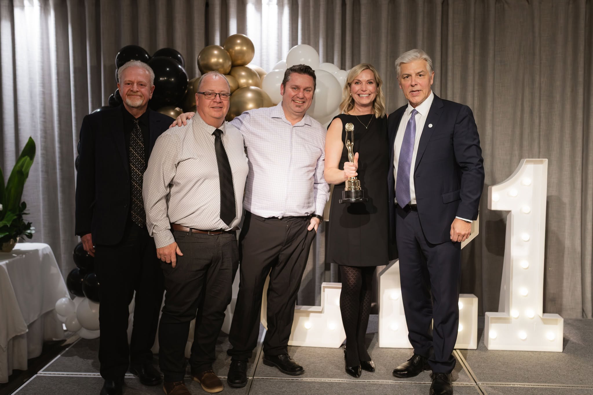 The partners of Century 21 Westman Realty Ltd. accepting a Centurion award together.