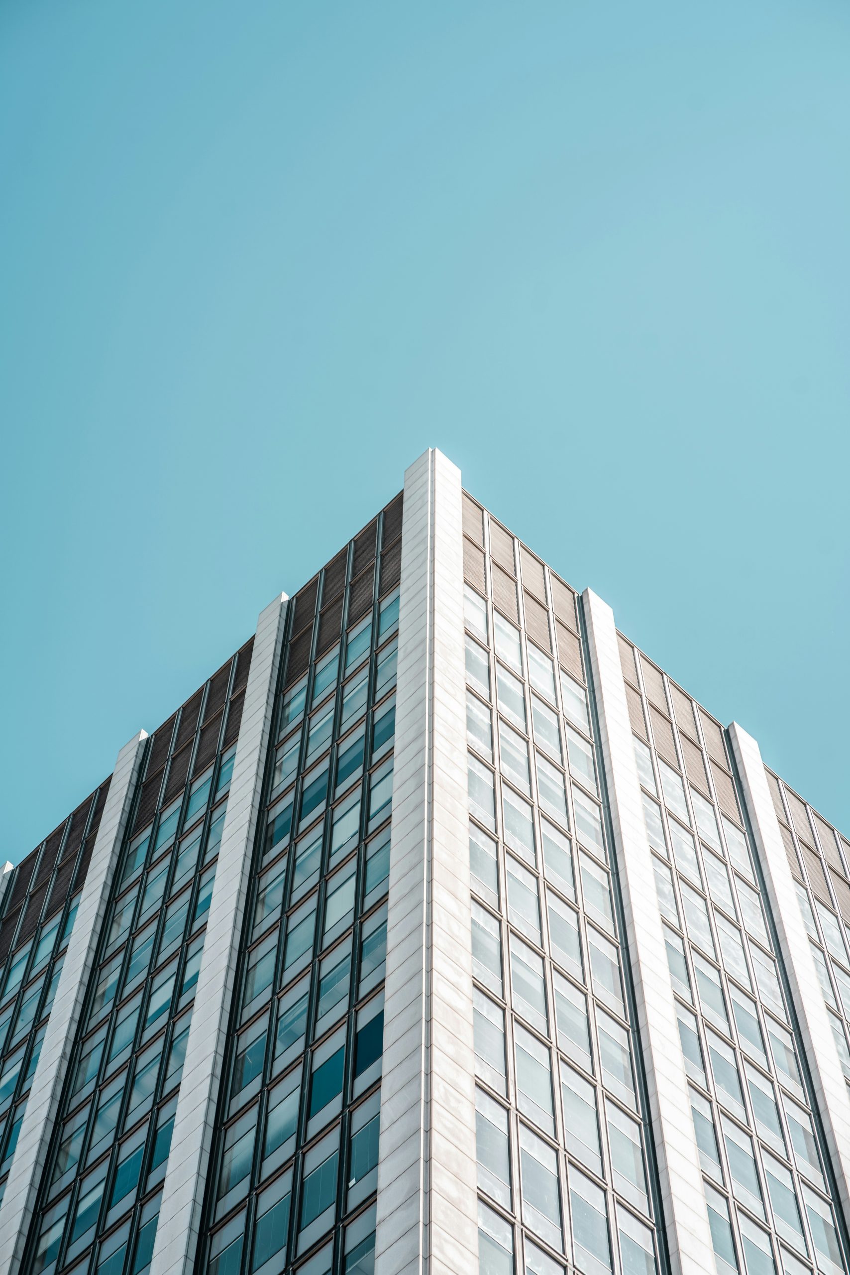 Looking up at a modern commercial office tower, representing commercial real estate.
